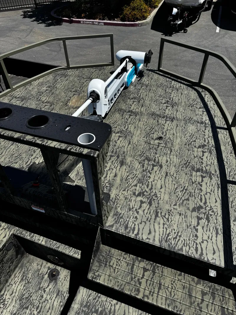 Slide: The Image of 2025 Tracker Grizzly 2072 CC Sportsman boat with camo deck and mounted equipment. - 7