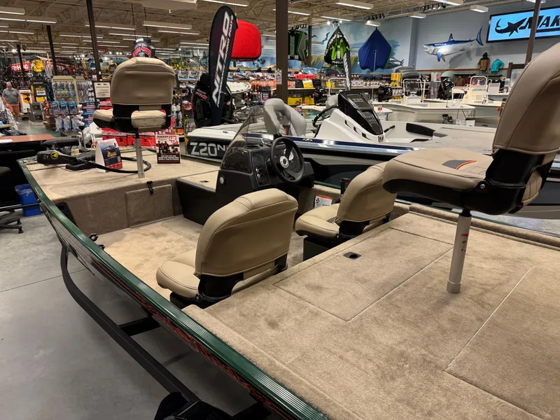 Slide: The Image of 2025 Tracker Bass Tracker Classic Limited boat displayed in a showroom with beige seating. - 2