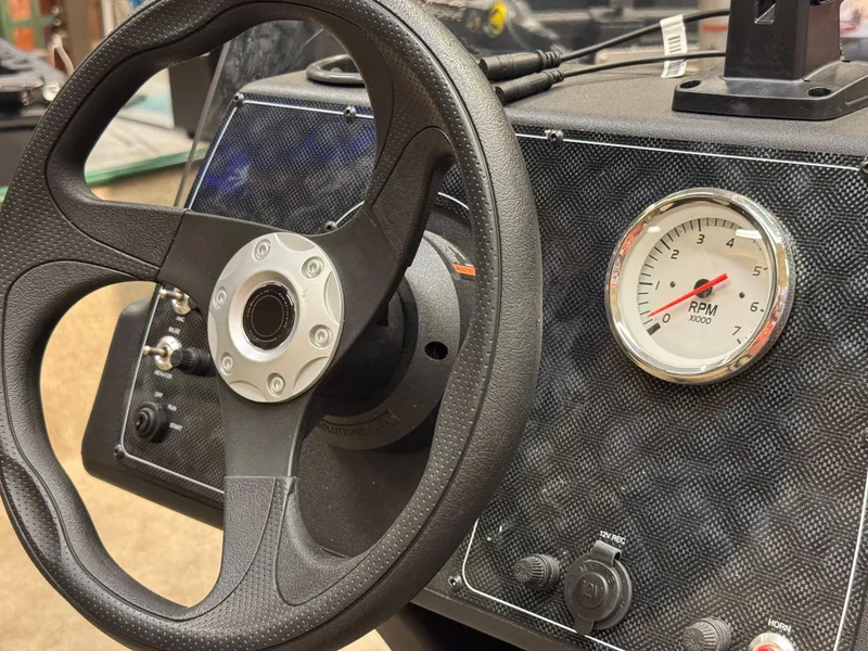 Slide: The Image of Steering wheel and RPM gauge of 2025 Tracker Bass Tracker Classic Limited boat. - 5