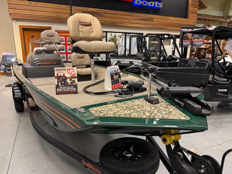 Slide: The Image of 2025 Tracker Bass Tracker Classic Limited boat displayed in showroom with fishing seats and equipment. - 7