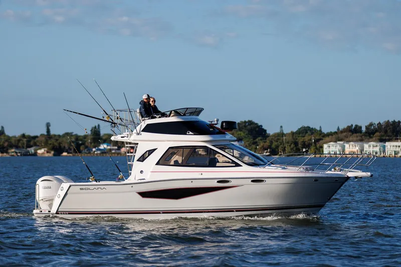 The Image of 2026 Solara S-310 Sport Bridge yacht cruising on a calm lake. - 0