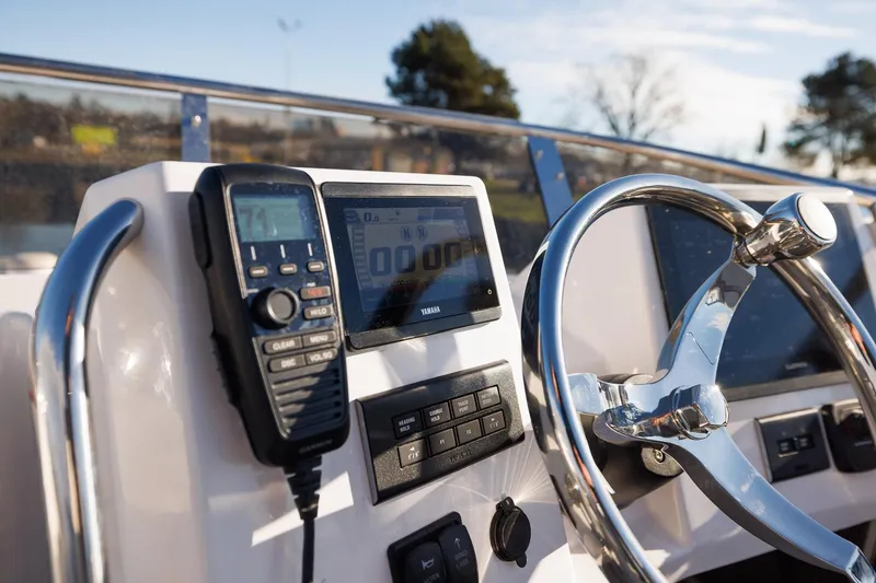 Slide: The Image of 2026 Solara S-310 Sport Bridge dashboard with steering wheel and electronic controls. - 11