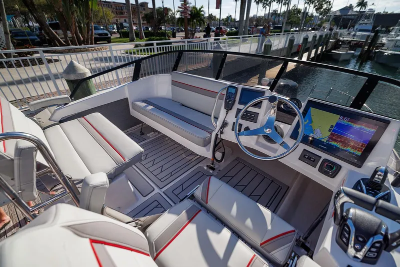 Slide: The Image of 2026 Solara S-310 Sport Bridge boat interior with modern dashboard and seating. - 12