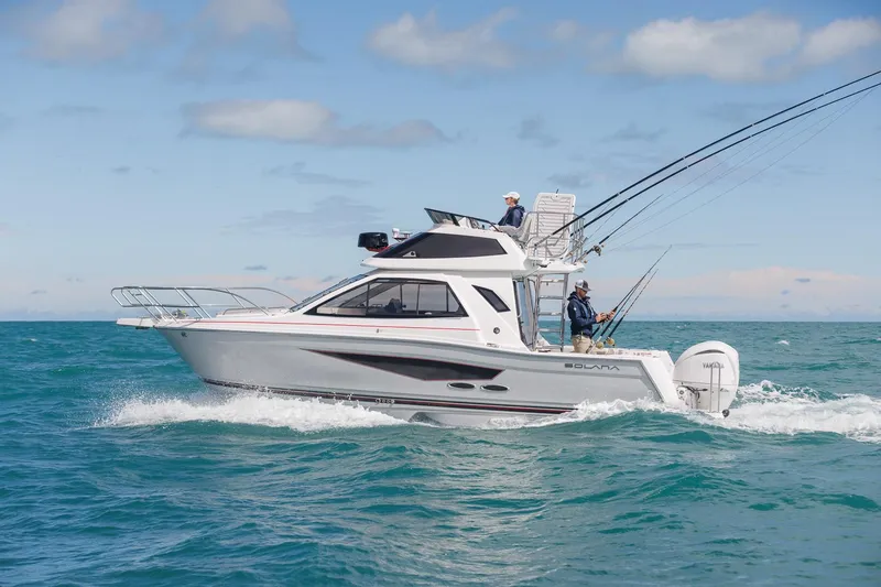 Slide: The Image of 2026 Solara S-310 Sport Bridge cruising on open water under a clear sky. - 3