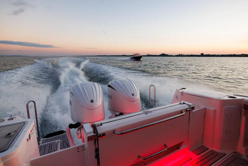 Slide: The Image of 2026 Solara S-310 Sport Bridge cruising at sunset with dual engines on open water. - 6