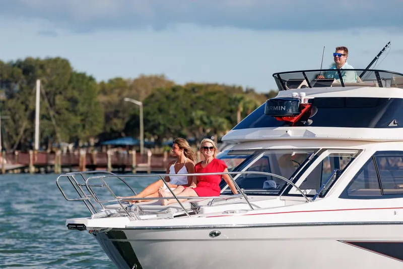 Slide: The Image of 2026 Solara S-310 Sport Bridge yacht cruising with passengers enjoying the sun. - 9