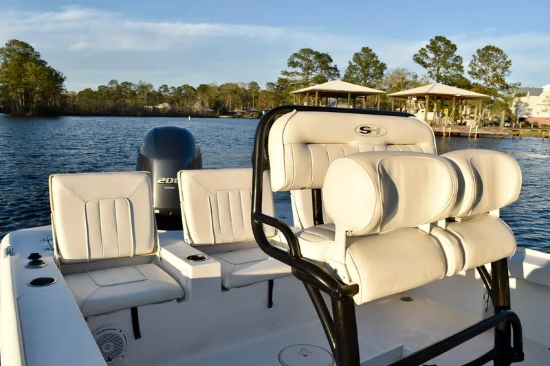 Slide: The Image of 2019 Sea Hunt BX 22 BR boat with seating, on a calm lake. - 14