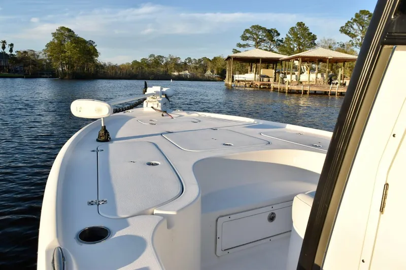 Slide: The Image of 2019 Sea Hunt BX 22 BR boat on calm water near docks and trees. - 8