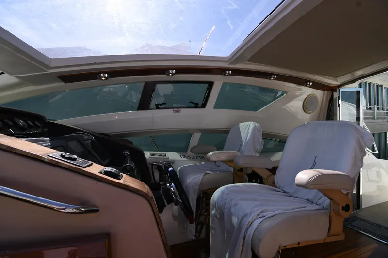 Slide: The Image of Interior view of 2008 Savannah 54 EXPRESS yacht cockpit with covered seats and control panel. - 29