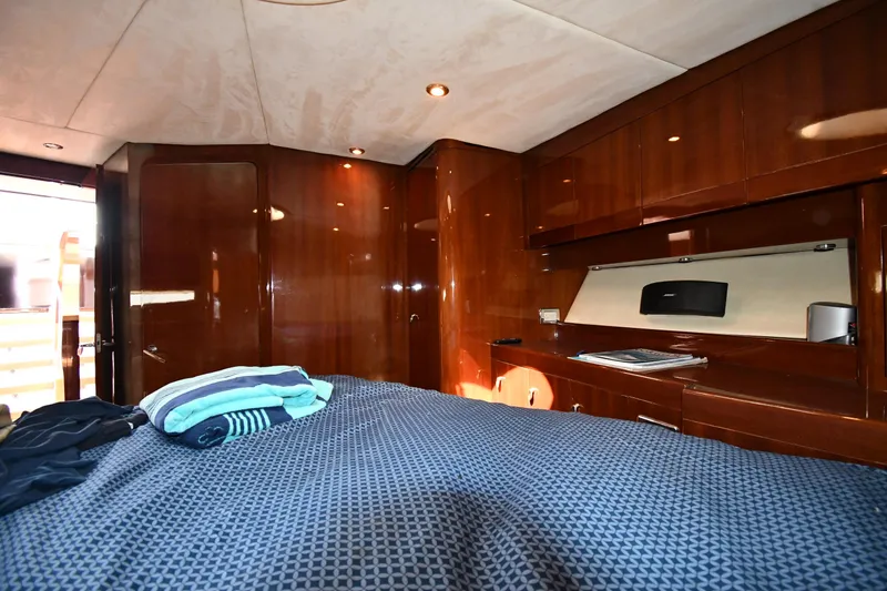 Slide: The Image of Luxurious cabin interior of 2008 Savannah 54 EXPRESS yacht with wood paneling and cozy bedding. - 48