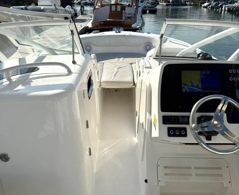 Slide: The Image of 2020 Edgewater 348 CX boat interior with steering wheel and navigation display. - 10