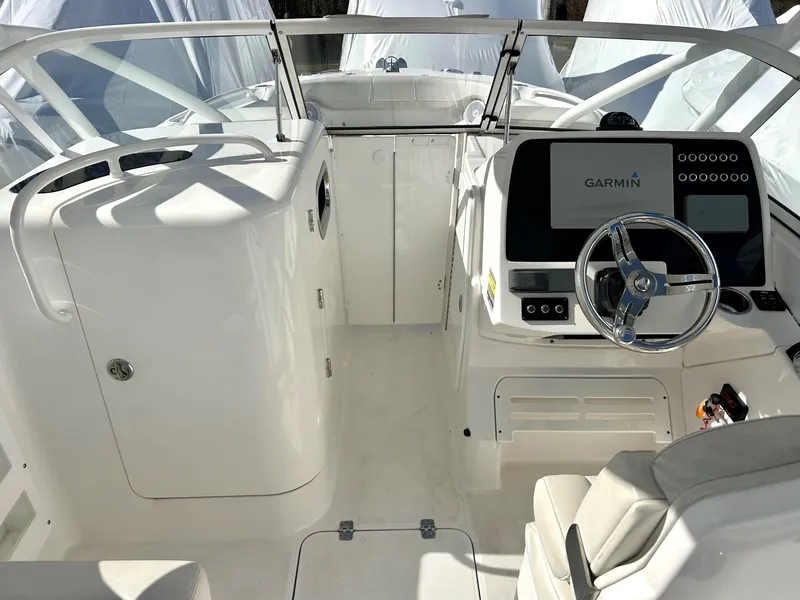 Slide: The Image of 2020 Edgewater 348 CX boat cockpit with Garmin navigation system and white interior. - 12