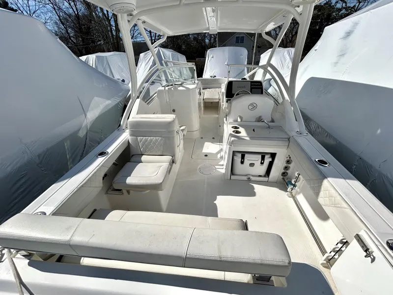 Slide: The Image of 2020 Edgewater 348 CX boat interior with seating and helm, covered in white upholstery. - 17