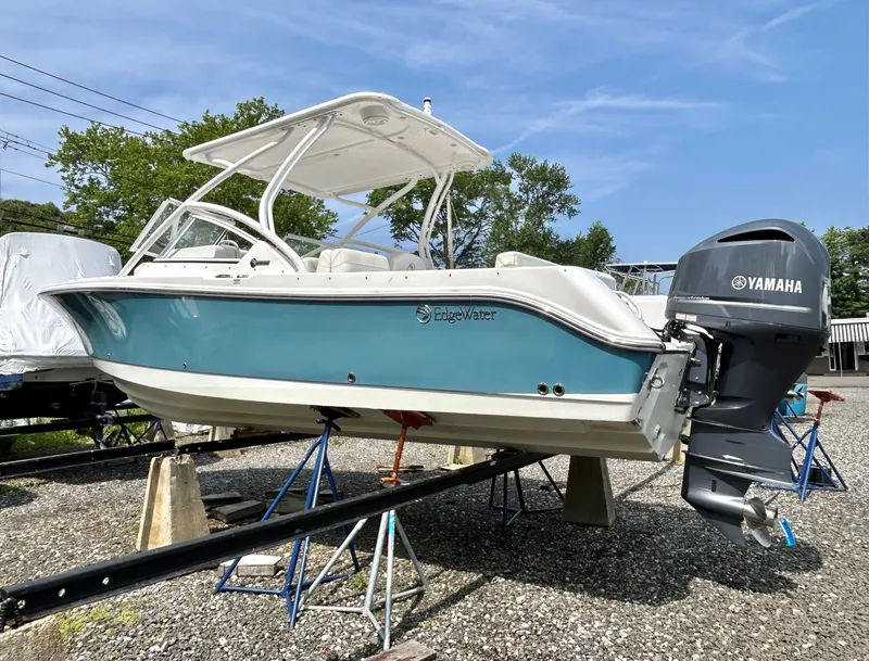 Slide: The Image of 2020 Edgewater 248 CX boat with Yamaha outboard engine on display outdoors. - 2