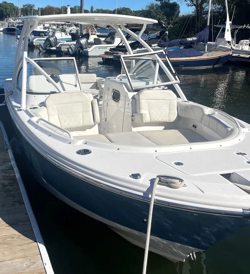 Slide: The Image of 2020 Edgewater 348 CX boat docked, featuring sleek design and spacious seating. - 6