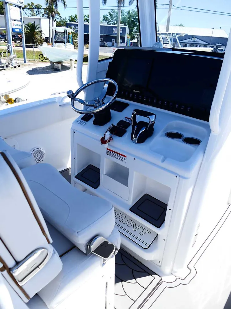 Slide: The Image of 2021 Sea Hunt Gamefish 27 helm with modern controls and spacious seating. - 14