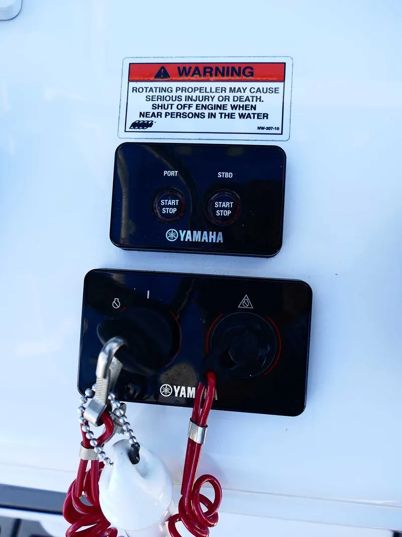 Slide: The Image of Yamaha engine controls on 2021 Sea Hunt Gamefish 27 boat with safety warning. - 19