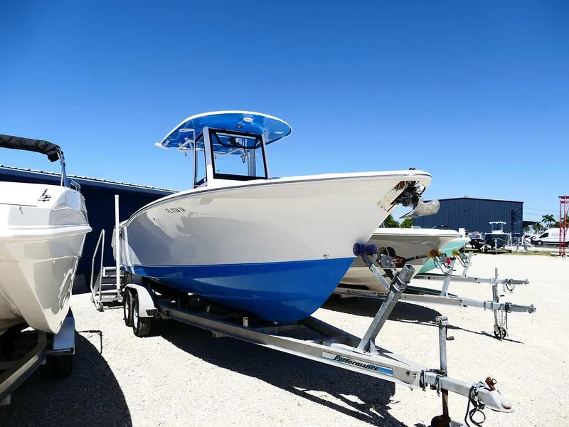 Slide: The Image of 2021 Sea Hunt Gamefish 27 with Coffin Box on trailer, blue and white design. - 2