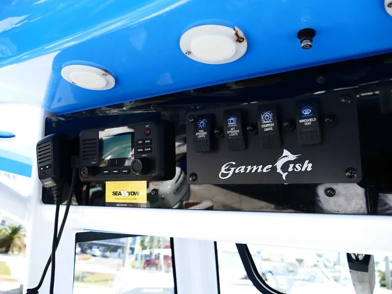 Slide: The Image of 2021 Sea Hunt Gamefish 27 control panel with radio and switches. - 21