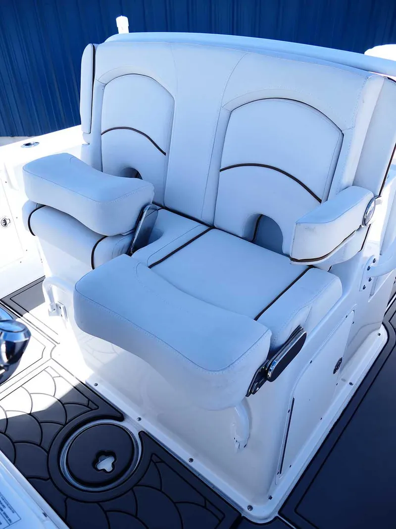 Slide: The Image of 2021 Sea Hunt Gamefish 27 boat seating with white cushioned chairs and armrests. - 25