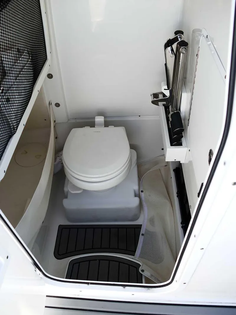 Slide: The Image of 2021 Sea Hunt Gamefish 27 boat interior with toilet and storage features. - 27