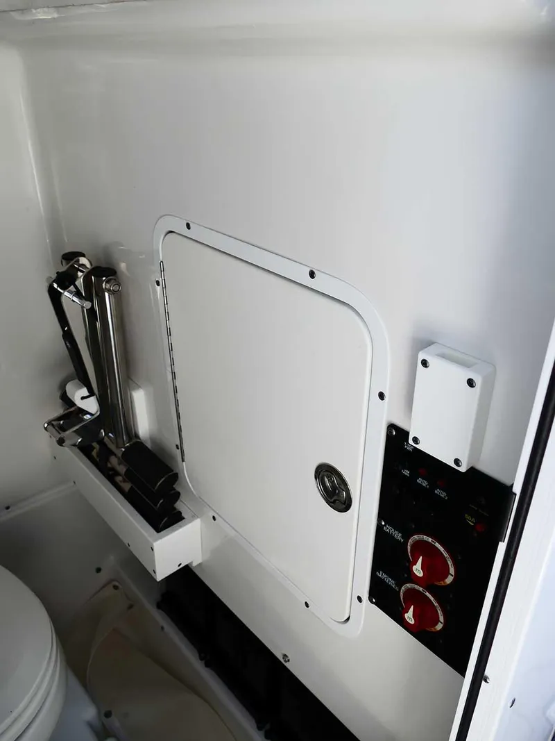 Slide: The Image of 2021 Sea Hunt Gamefish 27 interior, featuring storage compartment and control panel. - 28