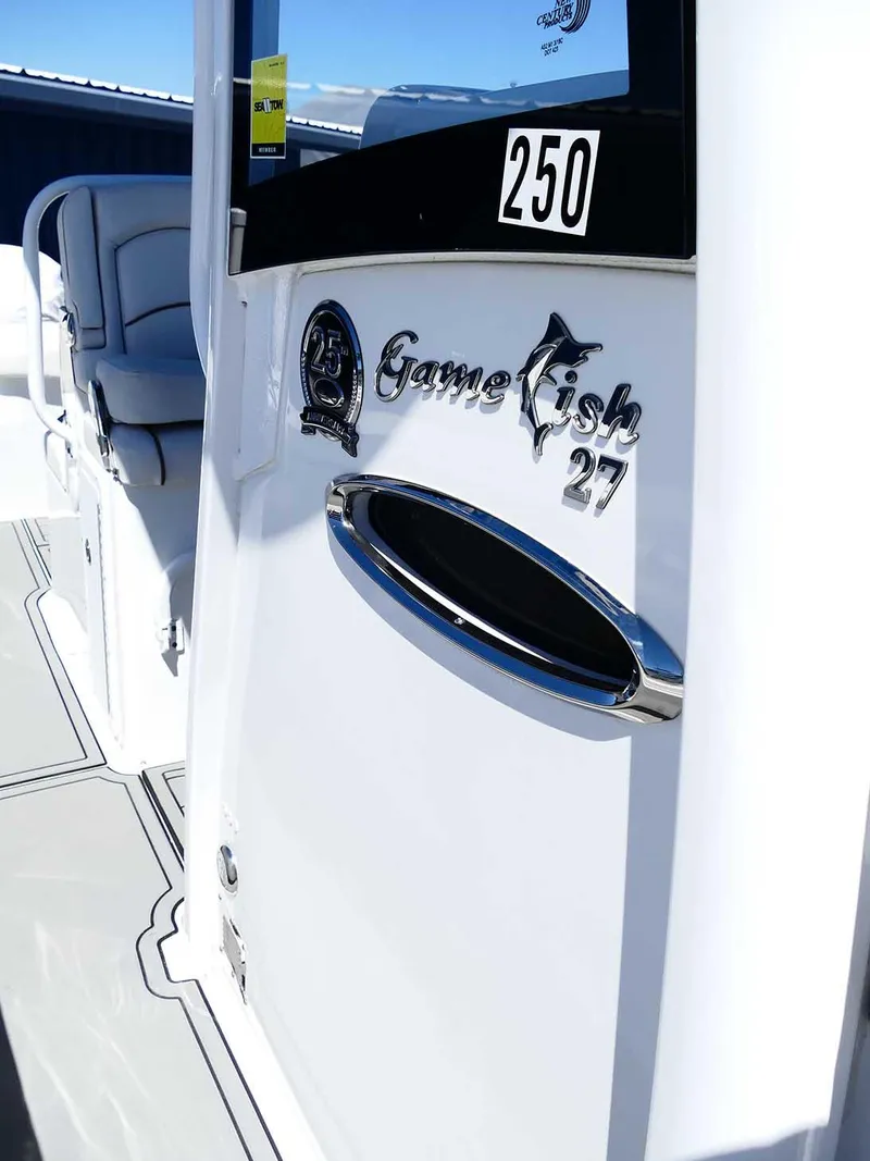 Slide: The Image of 2021 Sea Hunt Gamefish 27 boat with Coffin Box, sleek design, and chrome details. - 37