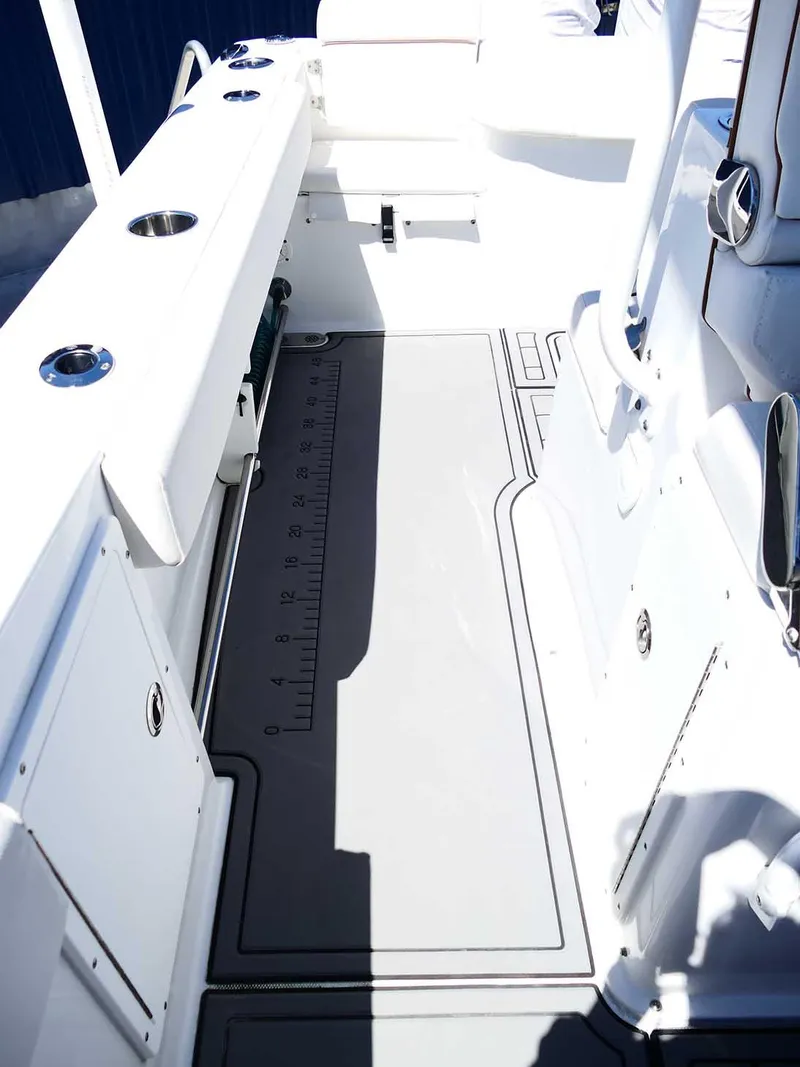 Slide: The Image of 2021 Sea Hunt Gamefish 27 interior with coffin box, featuring sleek white and gray design. - 39