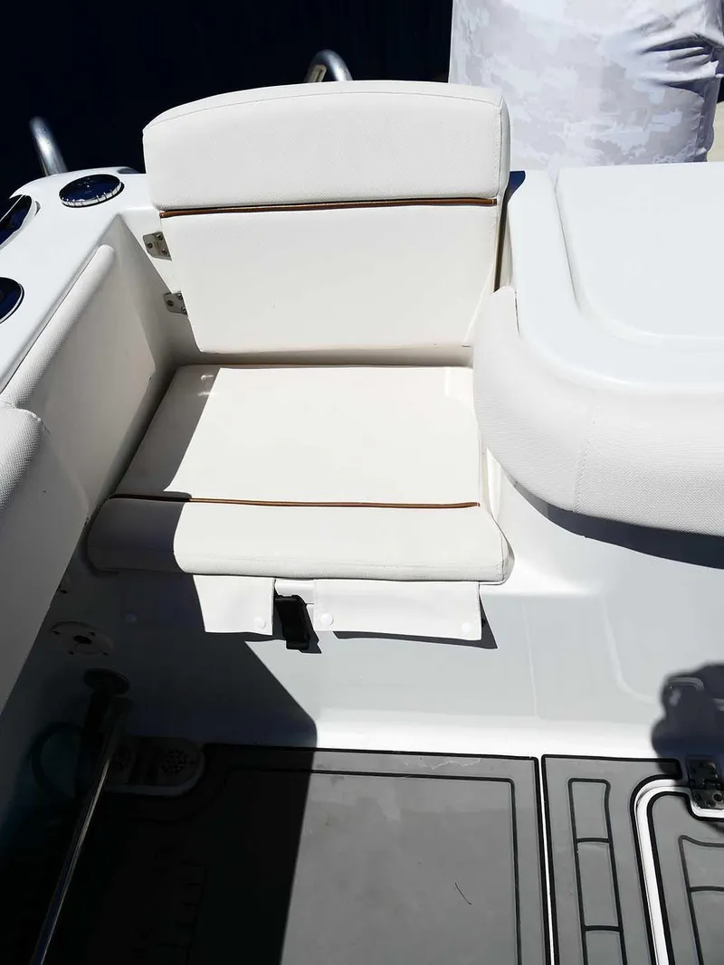 Slide: The Image of 2021 Sea Hunt Gamefish 27 boat interior with white seating and coffin box. - 45