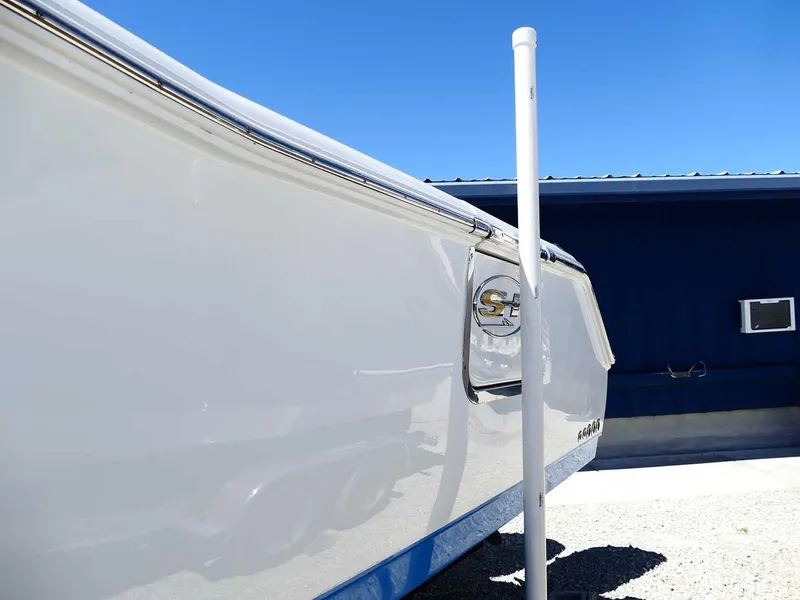 Slide: The Image of 2021 Sea Hunt Gamefish 27 boat side view with logo, against blue sky background. - 5