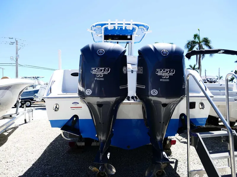 Slide: The Image of 2021 Sea Hunt Gamefish 27 with twin 250 V6 engines, parked outdoors. - 7
