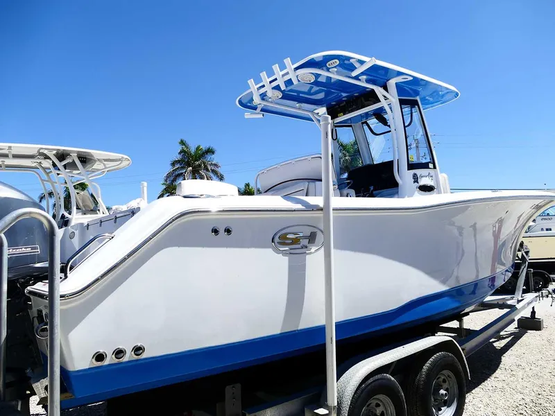 Slide: The Image of 2021 Sea Hunt Gamefish 27 with Coffin Box on trailer, featuring sleek design and blue accents. - 8