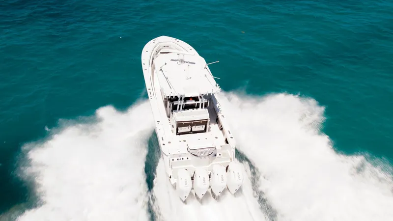 Slide: The Image of 2024 Blackfin 400 CC boat speeding on turquoise ocean waters. - 11