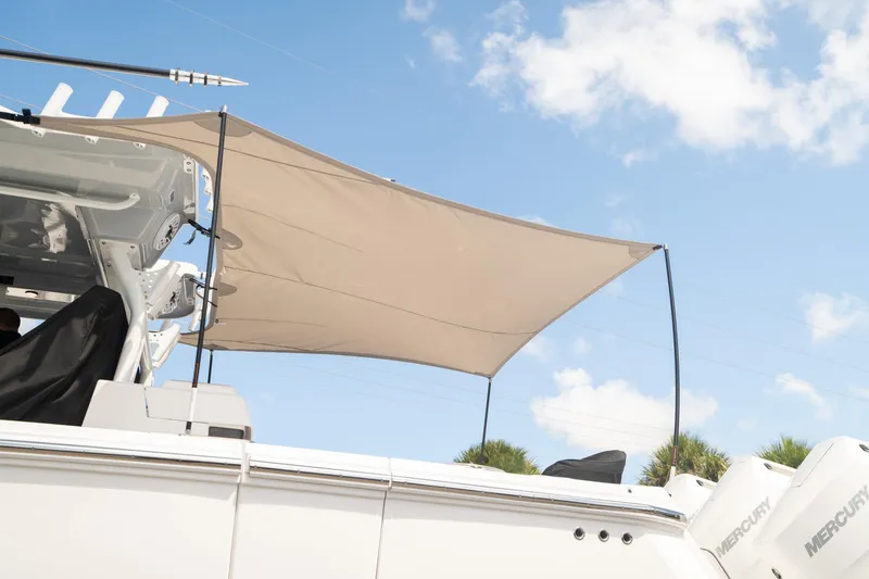 Slide: The Image of 2024 Blackfin 400 CC boat with sunshade under a clear blue sky. - 14