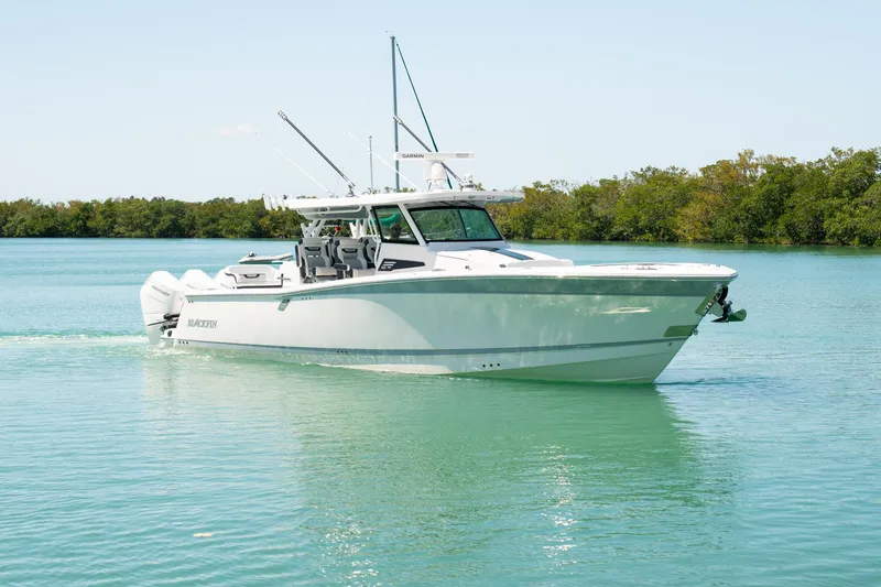 Slide: The Image of 2024 Blackfin 400 CC boat cruising on calm turquoise waters. - 2