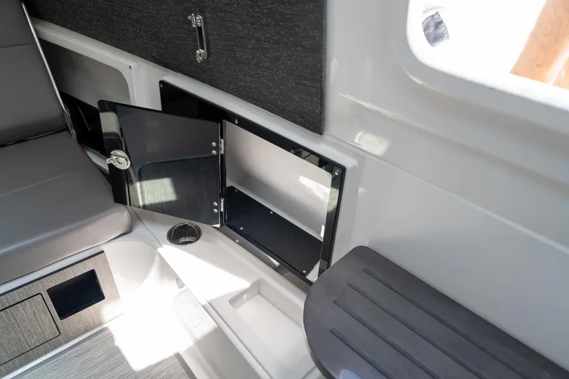 Slide: The Image of 2024 Blackfin 400 CC interior storage compartment with open door, showcasing sleek design. - 37