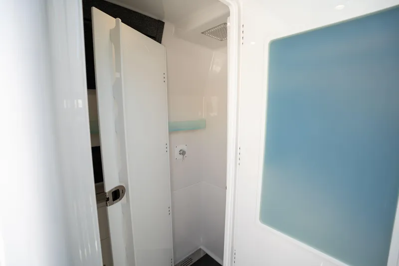 Slide: The Image of 2024 Blackfin 400 CC interior shower with modern design and sleek white finish. - 48