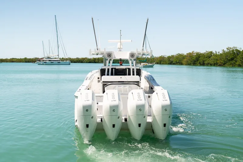 Slide: The Image of 2024 Blackfin 400 CC boat with quad engines cruising on clear water. - 5