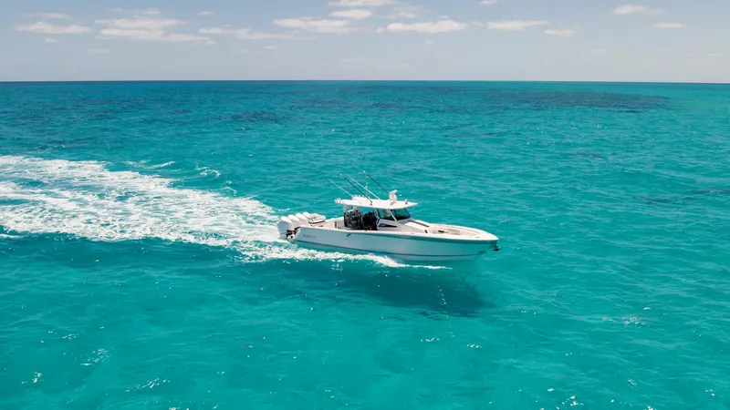 Slide: The Image of 2024 Blackfin 400 CC cruising on clear turquoise ocean waters. - 8