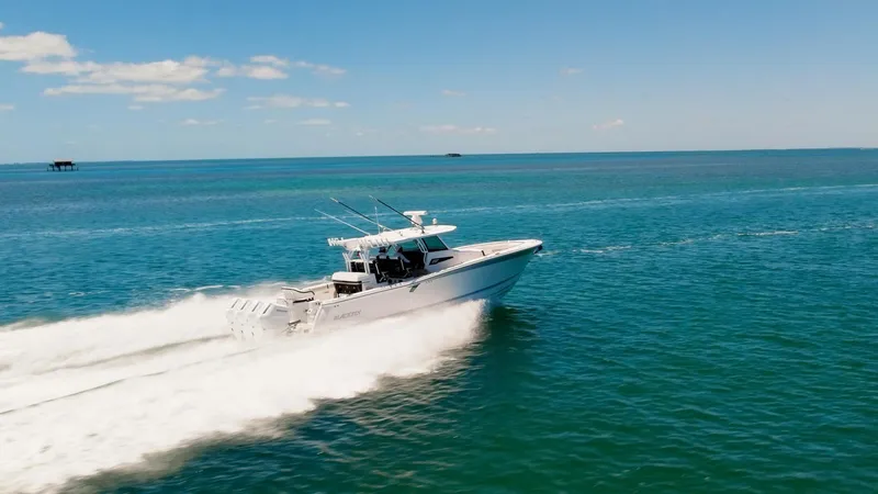 Slide: The Image of 2024 Blackfin 400 CC boat cruising on open blue water under clear skies. - 9