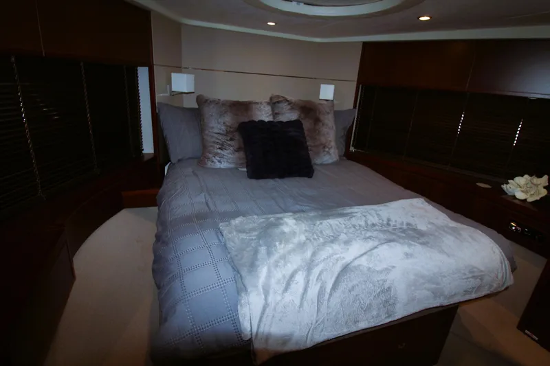Slide: The Image of Luxurious bedroom interior of 2013 Princess V62 yacht with plush bedding and ambient lighting. - 14