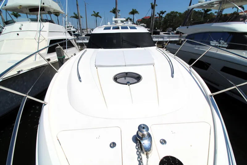 Slide: The Image of 2013 Princess V62 yacht docked at marina, surrounded by other boats. - 32