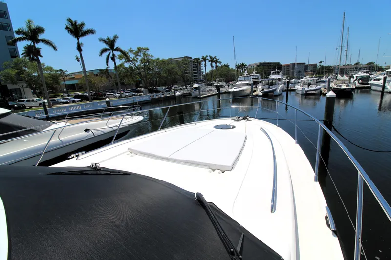 Slide: The Image of 2013 Princess V62 yacht docked at marina, surrounded by palm trees and other boats. - 35