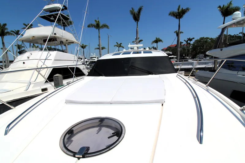 Slide: The Image of 2013 Princess V62 yacht docked with palm trees in the background. - 36