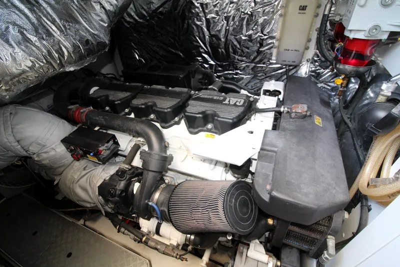 Slide: The Image of Engine room of a 2013 Princess V62 yacht, showcasing detailed machinery and components. - 47