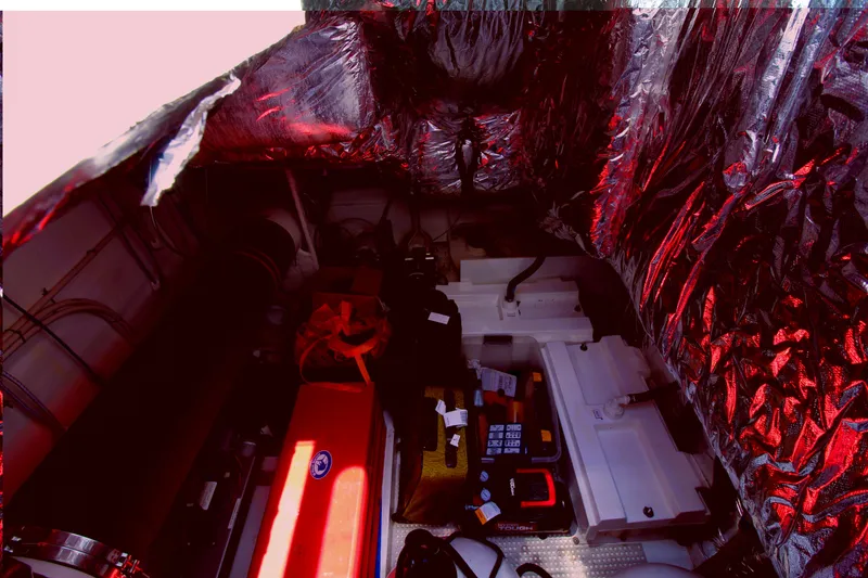 Slide: The Image of Engine room of a 2013 Princess V62 yacht with visible components and insulation. - 49