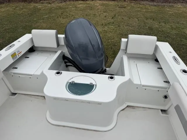 Slide: The Image of 2022 Parker 2120 Sport Cabin boat with outboard motor and seating. - 2