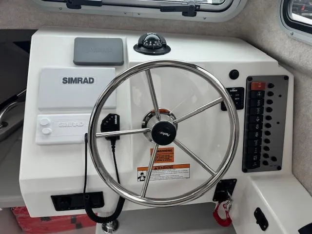 Slide: The Image of Steering wheel and controls of 2022 Parker 2120 Sport Cabin boat. - 4