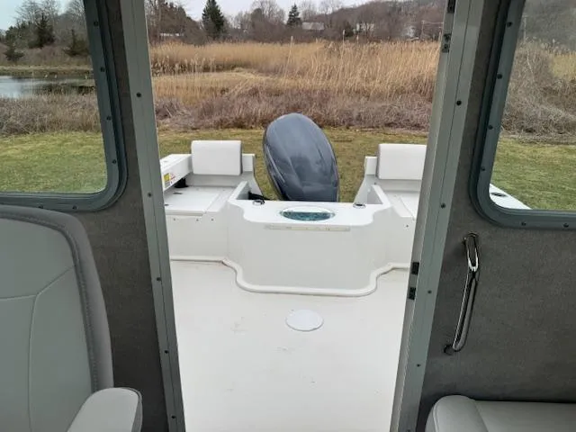 Slide: The Image of Parker 2120 Sport Cabin 2022 boat interior with outboard motor, viewed from cabin doorway. - 5