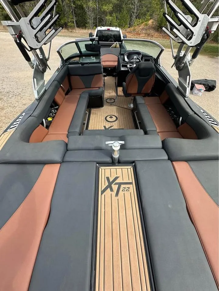 Slide: The Image of 2021 MasterCraft XT22 boat interior with sleek seating and modern design. - 2